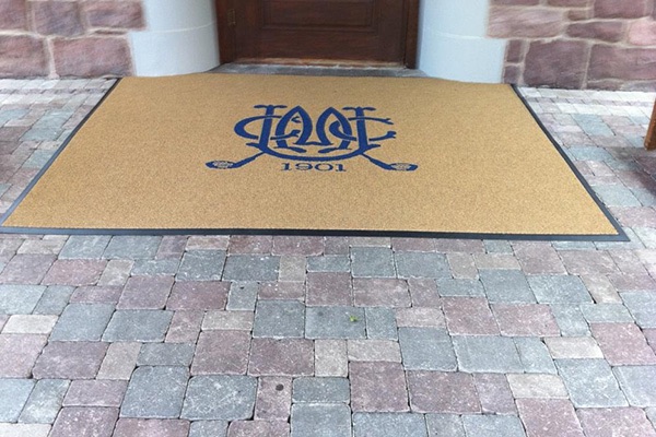 Custom monogram logo mat at a country club front door