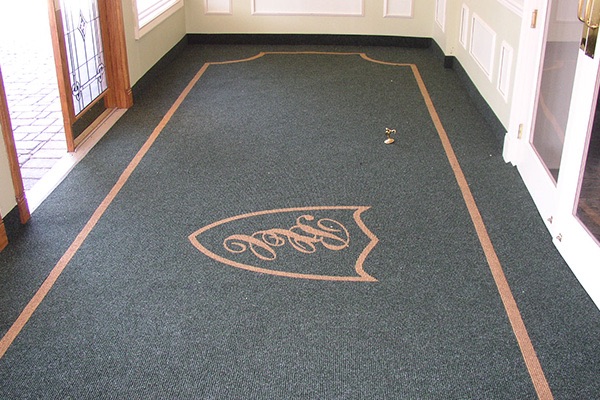 Custom crest carpet inside a country club entrance