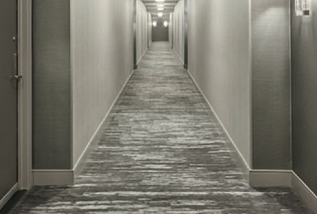 Custom carpet and gold lettered mat at a luxury hotel entrance