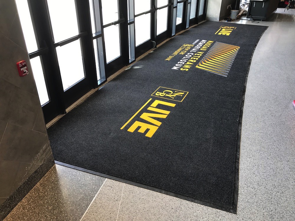 Custom logo matting reinforcing a client brand at an entrance