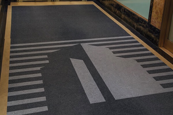 Custom building-silhouette logo mat in an office lobby