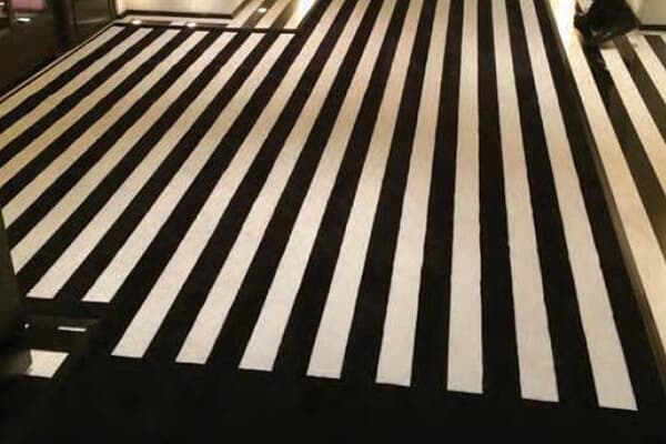 A black and white striped hotel mat adds flourish to a hotel. 